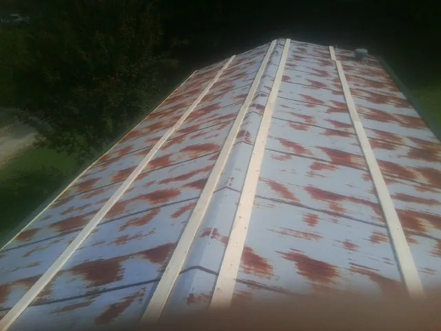 Rusted metal roof panels with new wood purlins before replacement — Storm Damage Roof Repair in Paul by Roofing Brothers